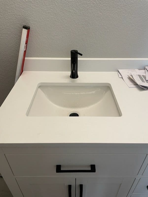 Gallery photos for Sleek Bathroom Transformation with Black Fixtures and Marble-like Tiles: Image #2